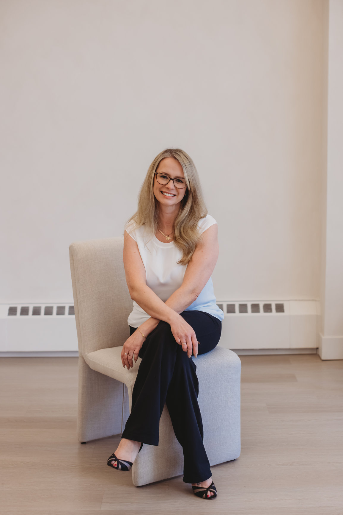 Sarah Hope seated in a bright room, listening with a calm, attentive expression